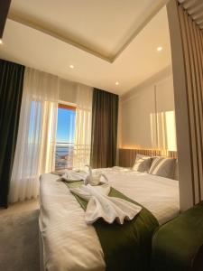 a bedroom with two beds and a large window at Apartmani Džanković in Kopaonik