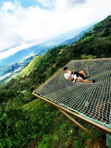a woman laying on a walkway over a hill at El paraíso de Butulu in La Vega