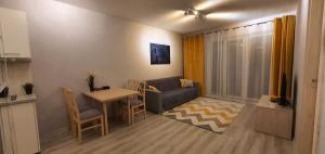 a small living room with a table and a couch at Seven days, 2 room's in Wrocław