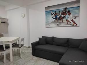a living room with a couch and a painting on the wall at Ca'Claudia Boavista in Sal Rei