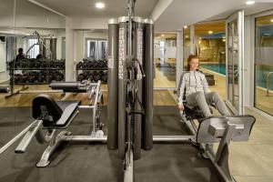 a woman sitting in a chair in a gym at Neo Hotel Linde Esslingen in Esslingen