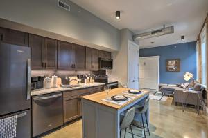 a kitchen with a island in the middle of a room at Sleek Studio Near Dtwn Dining and Entertainment in Cincinnati