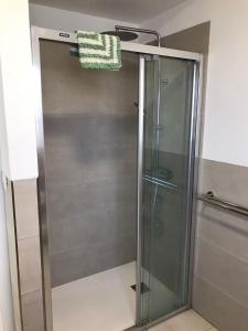 a shower with a glass door in a bathroom at Grosse Terrasse. Modern. Home office. Solarium in Los Realejos