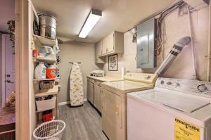 a small kitchen with a washer and dryer at Cozy Kansas City Home with Yard - 9 Mi to Dtwn! in Kansas City +25 photos