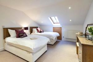 a bedroom with two beds and a skylight at Finest Retreats - Bretherdale Barn in Tebay