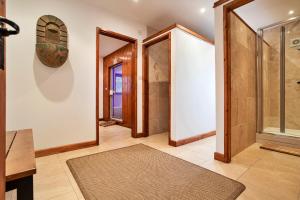 a hallway with two doors and a rug at Finest Retreats - Bretherdale Barn in Tebay +38 photos