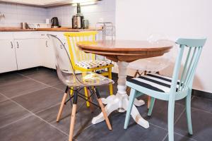 a kitchen with a wooden table and four chairs at Mediterranean House with private garden near Crikvenica in Drivenik