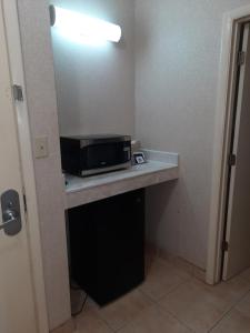 a microwave sitting on a counter in a hotel room at Quality Inn & Suites Grants - I-40 in Grants
