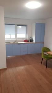 ein leeres Zimmer mit einem Tisch und einem grünen Stuhl in der Unterkunft Apartament 1 Budiu in Târgu Mureș