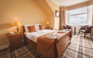 A bed or beds in a room at SGE Esplanade Hotel