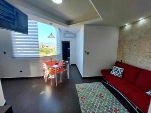 ein Wohnzimmer mit einem roten Sofa und einem Tisch in der Unterkunft Yaque Suite in El Yaque