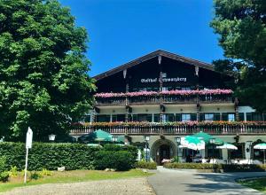a building with a balcony with flowers on it at Landgasthof Schwarzberg in Inzell