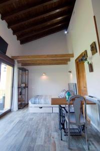 1 dormitorio con 1 cama, mesa y sillas en Apartamentos ECOviella, en Coviella