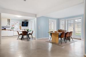 a kitchen and dining room with a table and chairs at Unstad Arctic Resort in Unnstad +97 photos