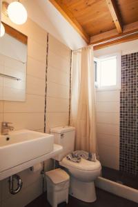 a bathroom with a white toilet and a sink at Aegeo Inn in Antiparos