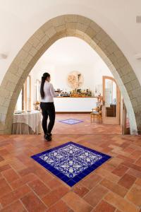 a woman standing in an archway in a room at Hotel Umberto A Mare in Ischia