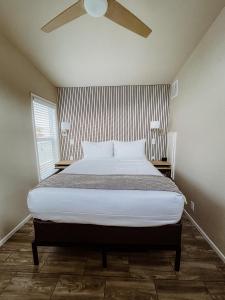 a bedroom with a bed with a ceiling fan at Flying Flags Avila Beach in Avila Beach