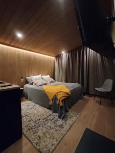 a bedroom with a bed with a rug at Black Hotel in Kempele