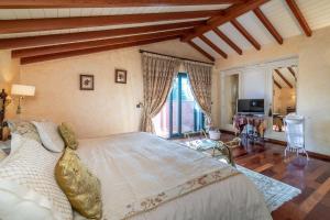 a bedroom with a large bed and a television at Villa Olivar - 5 BDR Dream Pool/Jacuzzi/Golf/BBQ in Torremolinos