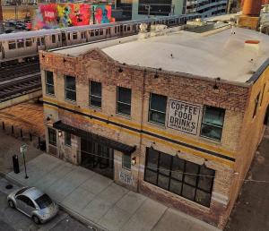 an old brick building with a sign that reads coffee food banks at The Chicago Hotel Collection River North in Chicago