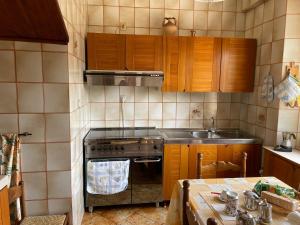 a kitchen with a stove and a sink at A casa di Zia Maria - Fuscaldoapartment in Fuscaldo
