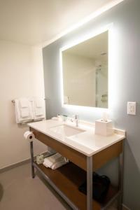 a bathroom with a sink and a large mirror at EVEN Hotel Manchester Airport, an IHG Hotel in Manchester