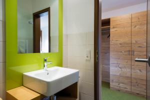 a bathroom with a white sink and a mirror at Gasthaus Zum Hirschen in Staufen im Breisgau +60 photos