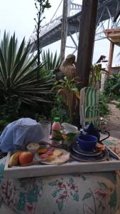 a table with a tray of food on it at Suites Villa Forte Santana in Florianópolis