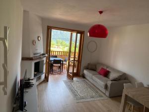 a living room with a couch and a table at Casa Giulia - Appartamento Anfo in Anfo