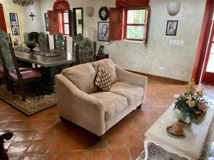 a living room with a couch and a table at Hotel Casa María Félix in Álamos