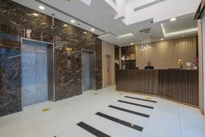 a lobby with a reception desk in a building at Vista City Hotel in Dubai