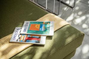 a book sitting on top of a bed at Olive Lemon Biophilic House & Lush Forest Garden in Vamos