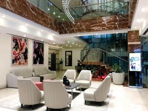 a lobby with a waiting room with white chairs at Waldorf Hotel in Caracas +56 photos