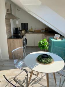 a table with a plant on it in a kitchen at Queen Flat in Old Town with Castle view in Bratislava