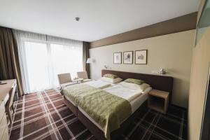 a hotel room with a large bed and a window at Hotel Split in Kadaň +37 photos