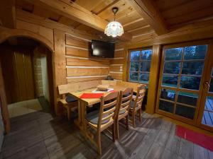 a dining room with a table and chairs in a cabin at Nasa Chata in Levoča