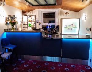 a bar in a restaurant with blue lighting at The Kynance House on Plymouth Hoe ,26 Ensuite Rooms in Plymouth