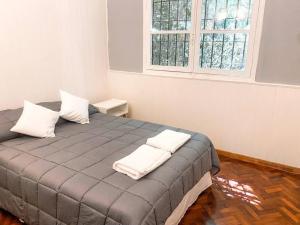 a bedroom with a bed with two pillows on it at Casa en el Bosque con piscina in Ciudad Lujan de Cuyo