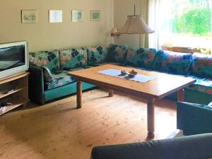 a living room with a couch and a coffee table at 4 person holiday home in R RVIK in Rörvik