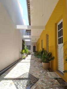 an empty hallway of a building with plants at Residencial Sol Nascente in Aracaju