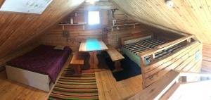 a room with a bed and a table in a cabin at Northern lights home opposite the mountains in Ylikyro