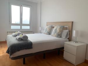 A bed or beds in a room at OKTHEWAY Castelao Street