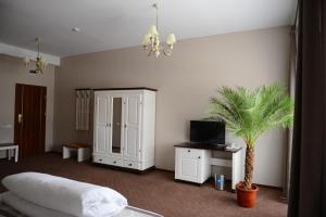 a bedroom with a bed and a palm tree in it at Hotel Europa in Baia Mare
