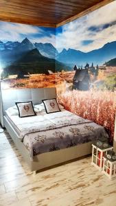 a bedroom with a wall mural of a mountain at Pod Śnieżynką in Zakopane