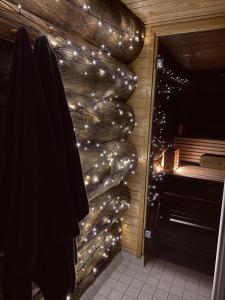 a bathroom with lights on a wall next to a piano at Ruka Chalet Roma in Ruka