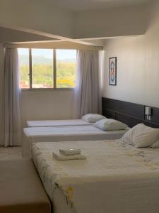 Postel nebo postele na pokoji v ubytování Hotel Comoditá Ltda
