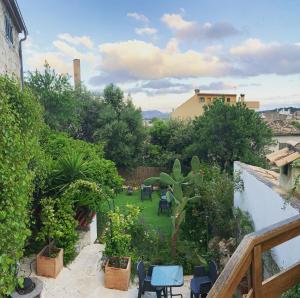 a view of a garden with chairs and plants at Casa Caimari Guest House, for mountain lovers! in Caimari