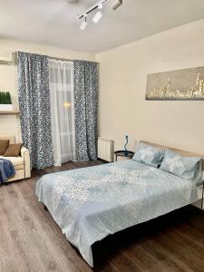 a bedroom with a large bed and a window at Apartment near Zybitskaya in Minsk