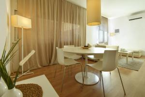 a dining room with a white table and white chairs at Luxury Battisti in Padova
