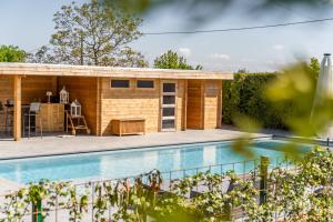 a tiny house next to a swimming pool at CellSphair in Houyet